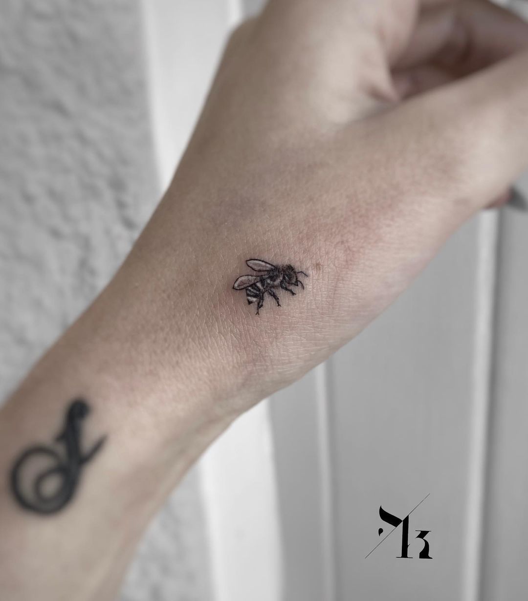Tiny bee tattoo