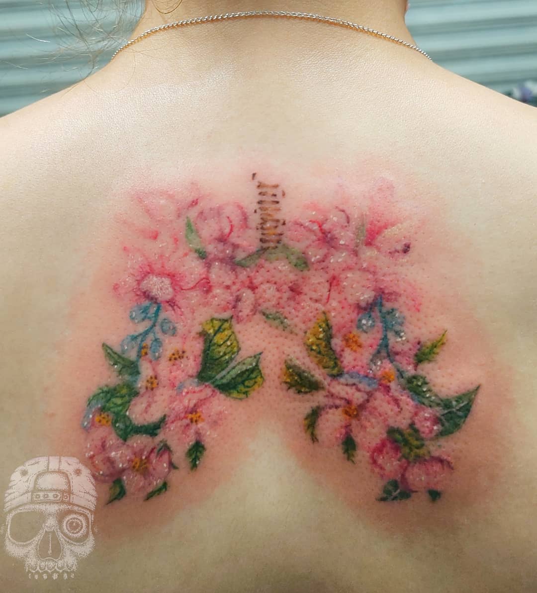 Flower Upper Back Tattoo