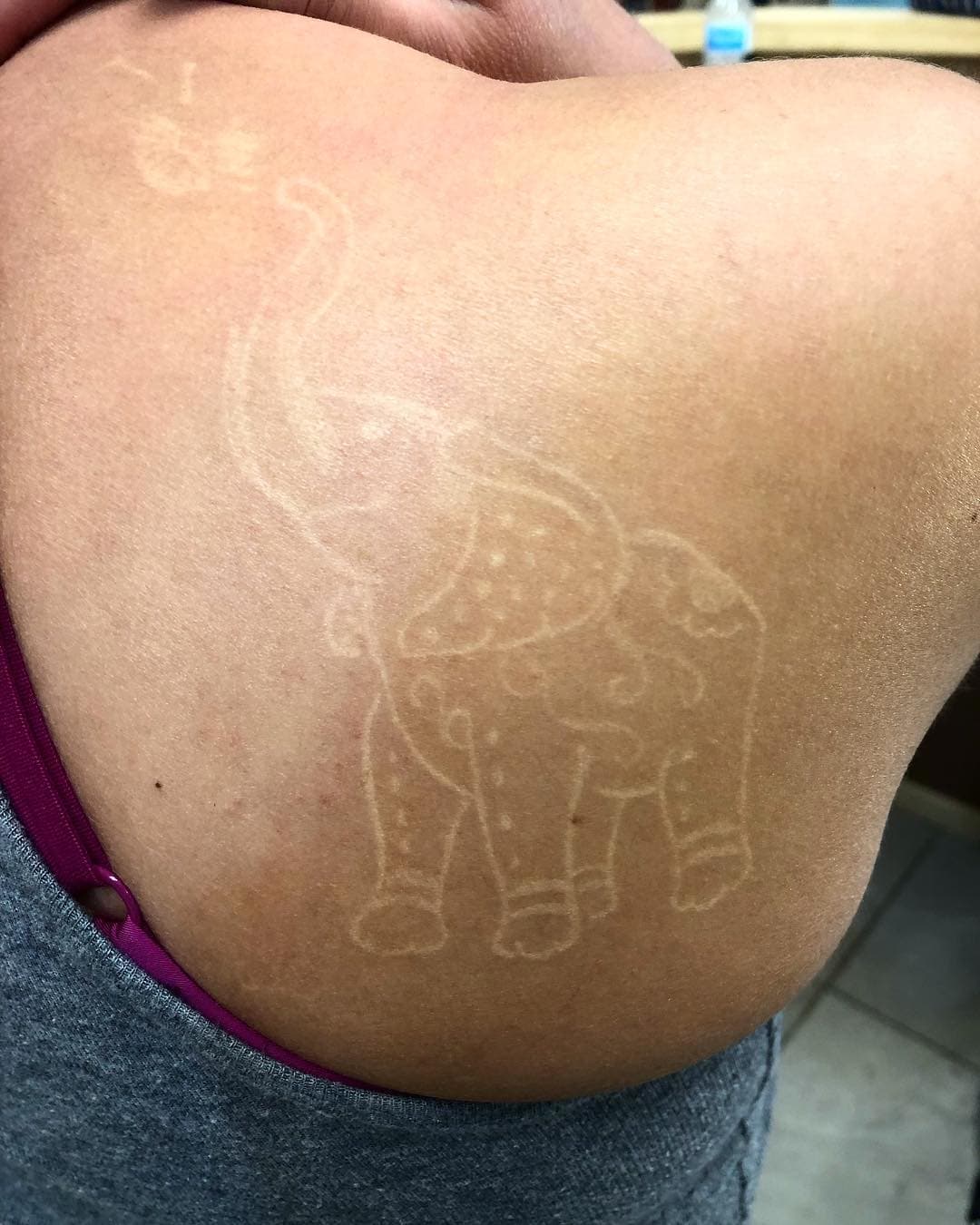 Weiße Tinte Tattoos auf dunkler Haut Held Tattoo Elefant 1