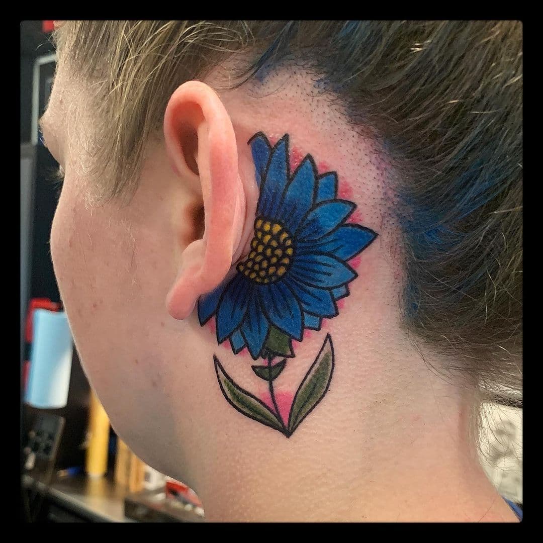 Flor azul detrás del tatuaje del héroe
