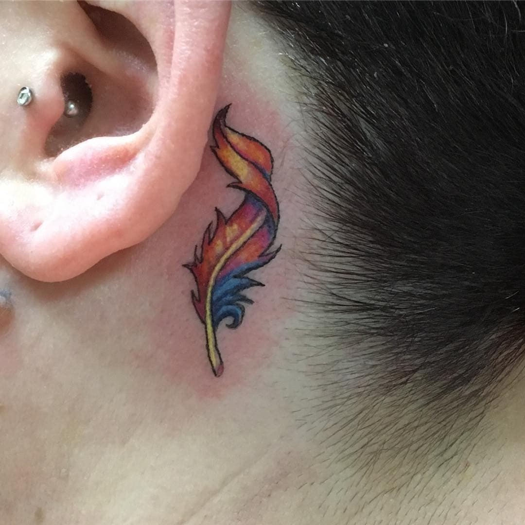 Colorful feather behind the tattoo hero tattoo 1