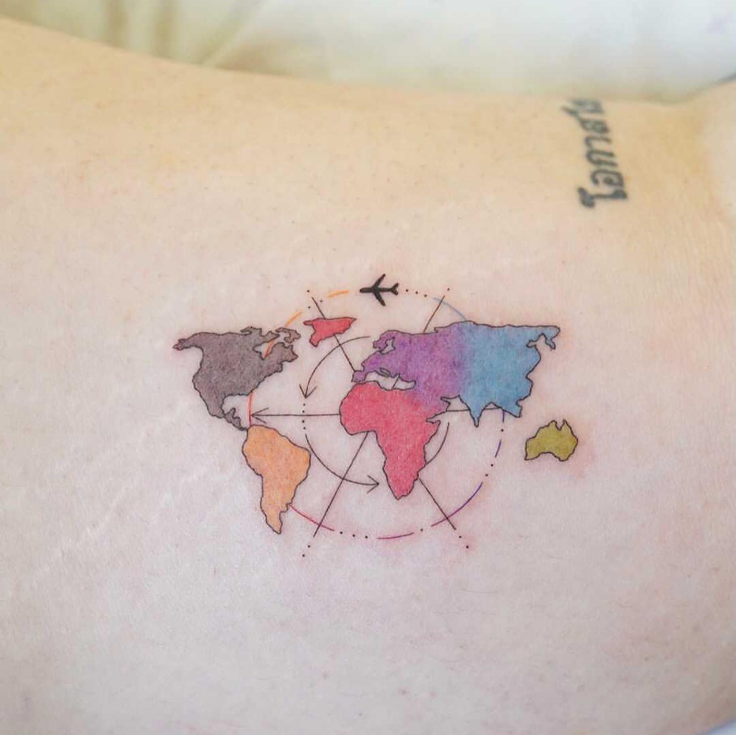 Tatuaje de un avión en el mapa del mundo