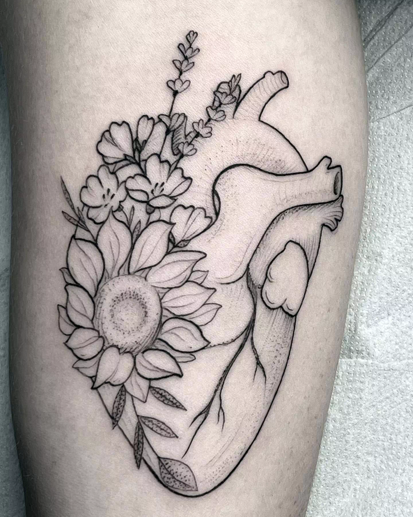 floral anathomic heart tattoo