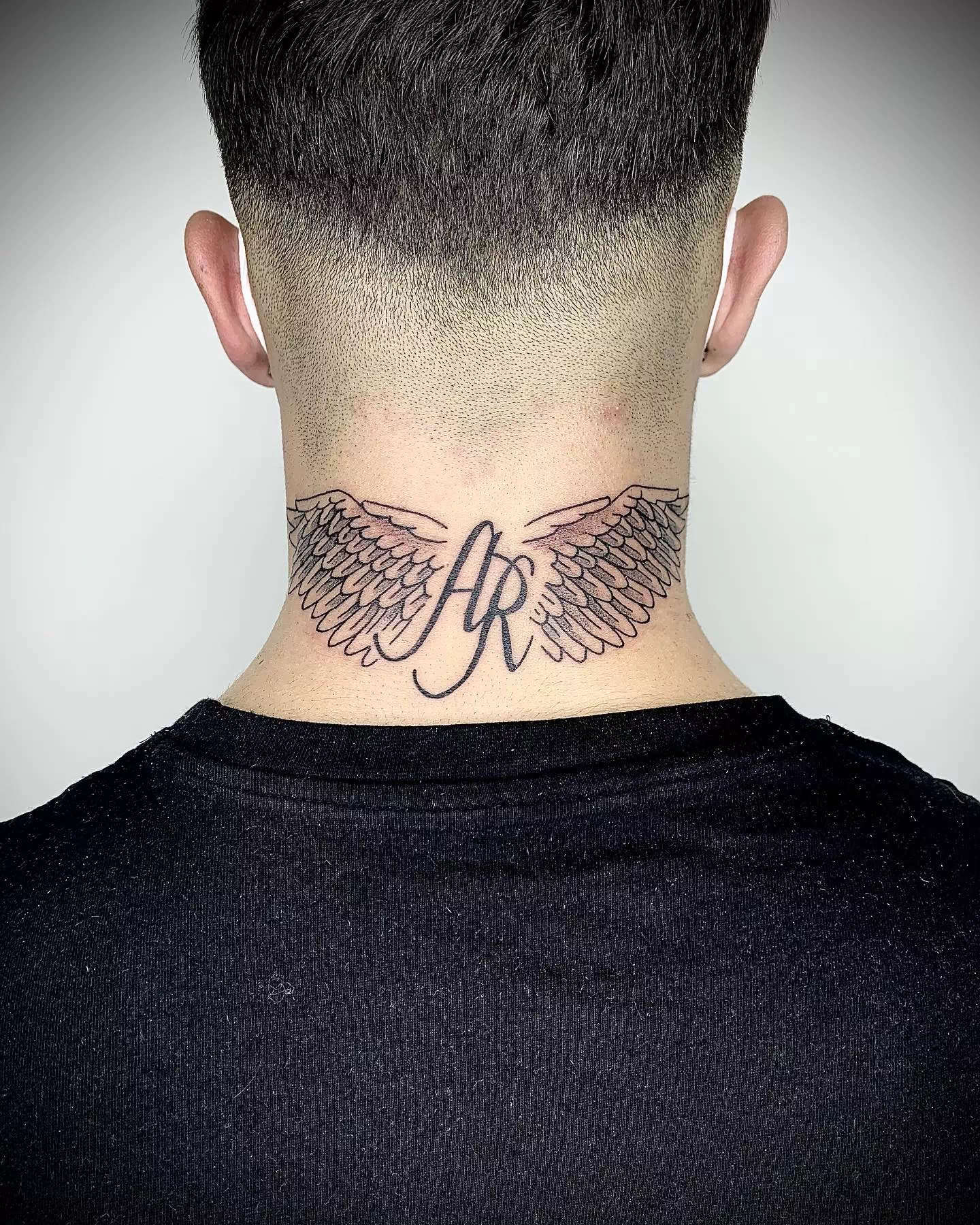 Wing neck tattoo 1