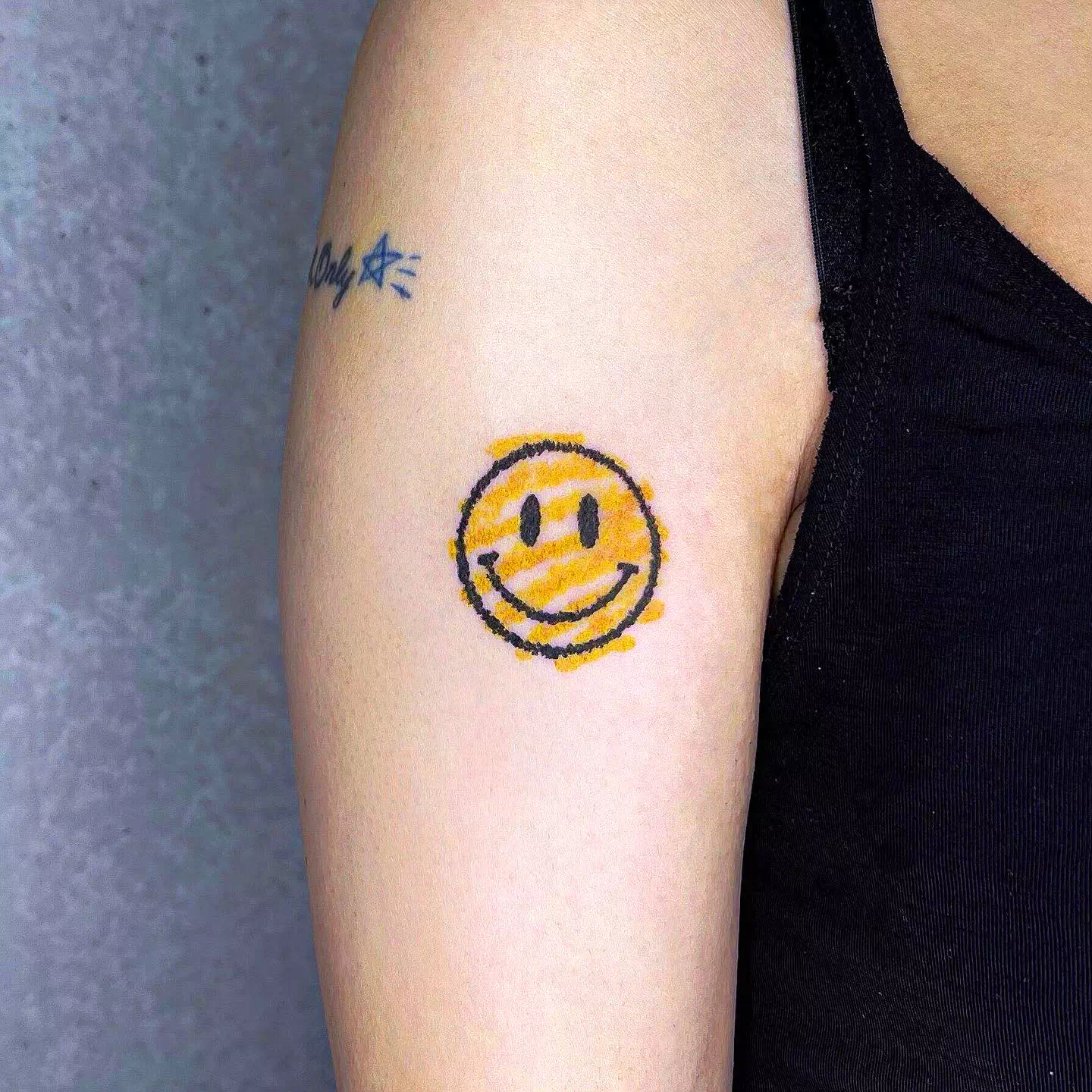 Tatuaje de una sonrisa optimista amarilla