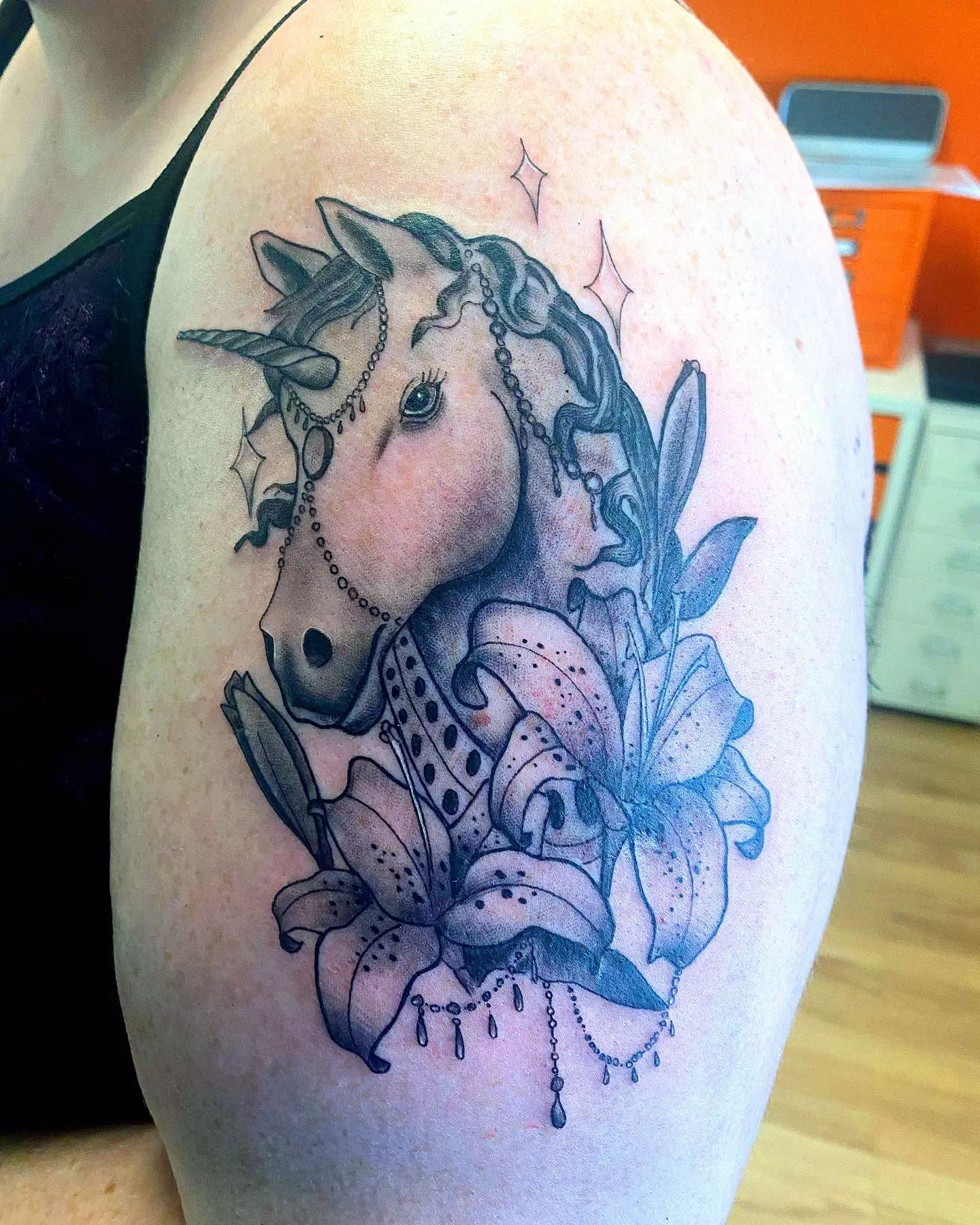 Black Unicorn Tattoo With Flowers