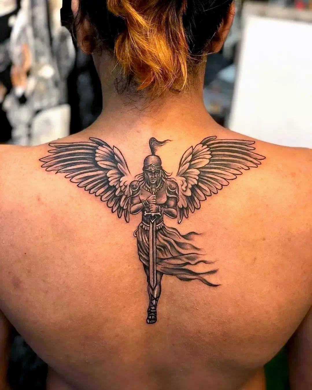 Wings neck tattoo 1